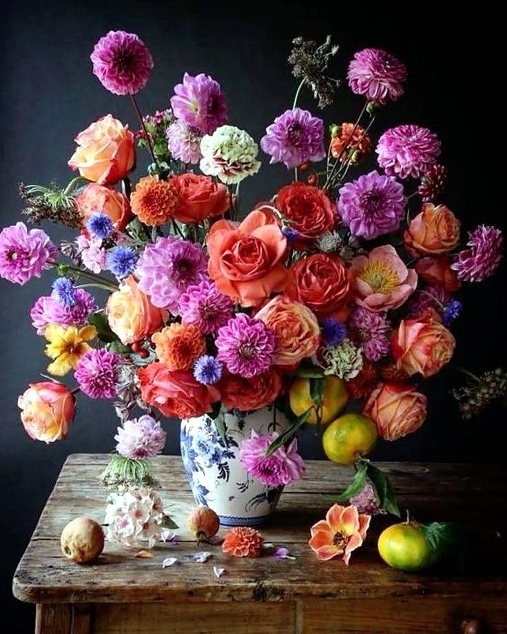 Dahlias and roses in a mixed vase arrangement